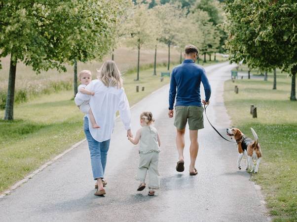 A family walking with dogs
AI-generated content may be incorrect.