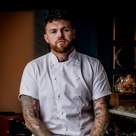 A person in a chef's uniform
AI-generated content may be incorrect.
