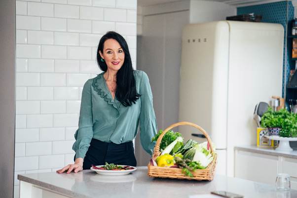 A person standing in front of a basket of vegetables
AI-generated content may be incorrect.